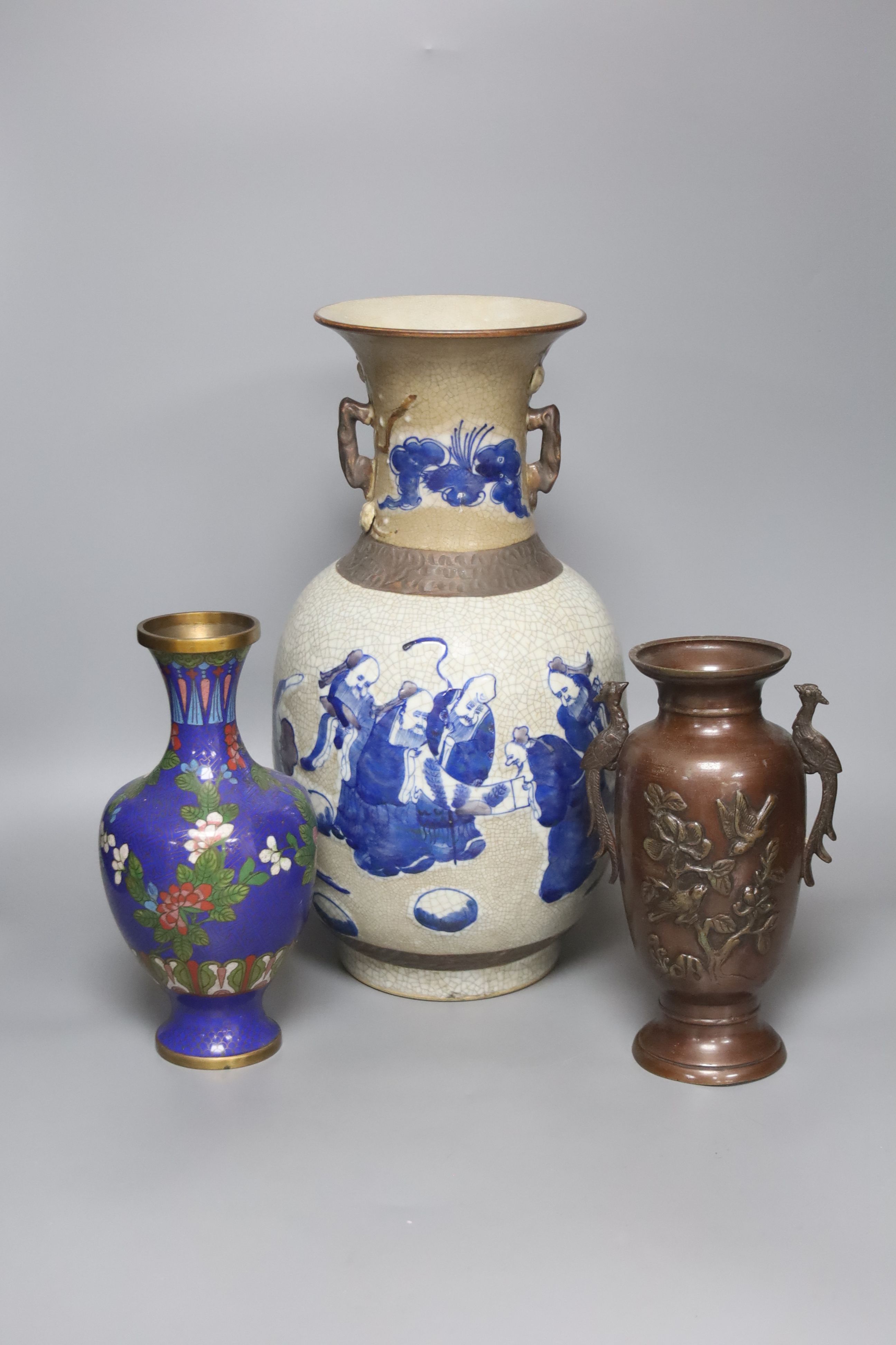 A Chinese blue and white crackle glaze vase, a similar cloisonne vase and a bronze vase, tallest 38cm